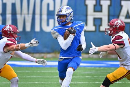 Hartwick College football player running with ball