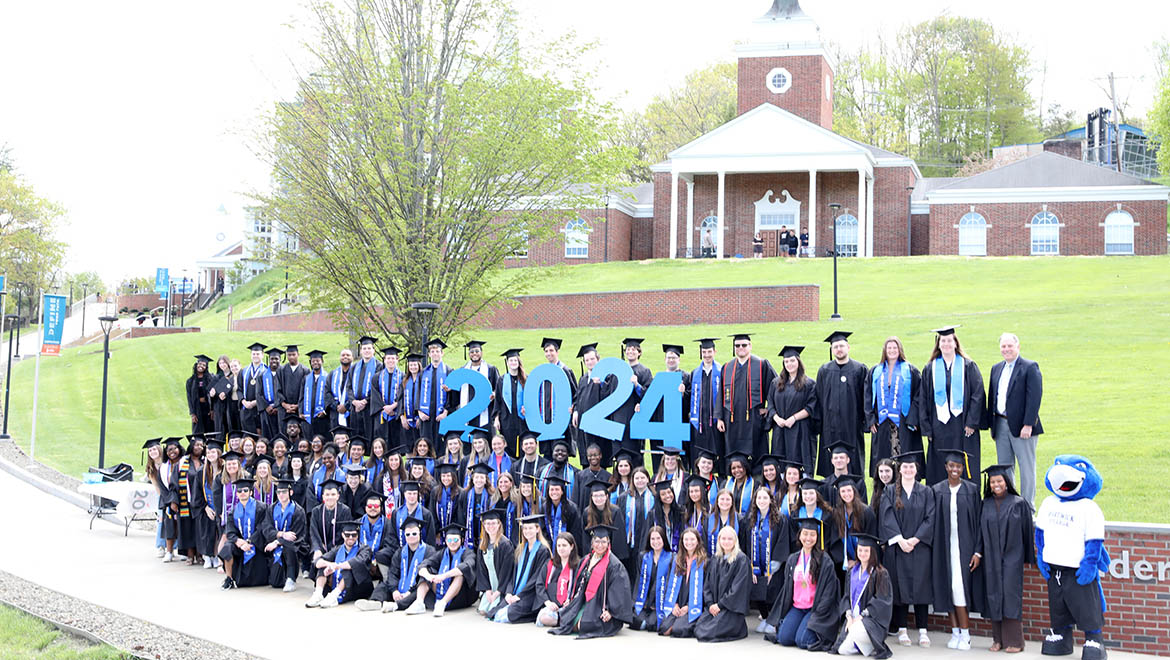 Hartwick College graduates of the Class of 2024 class photo on Founders' Way