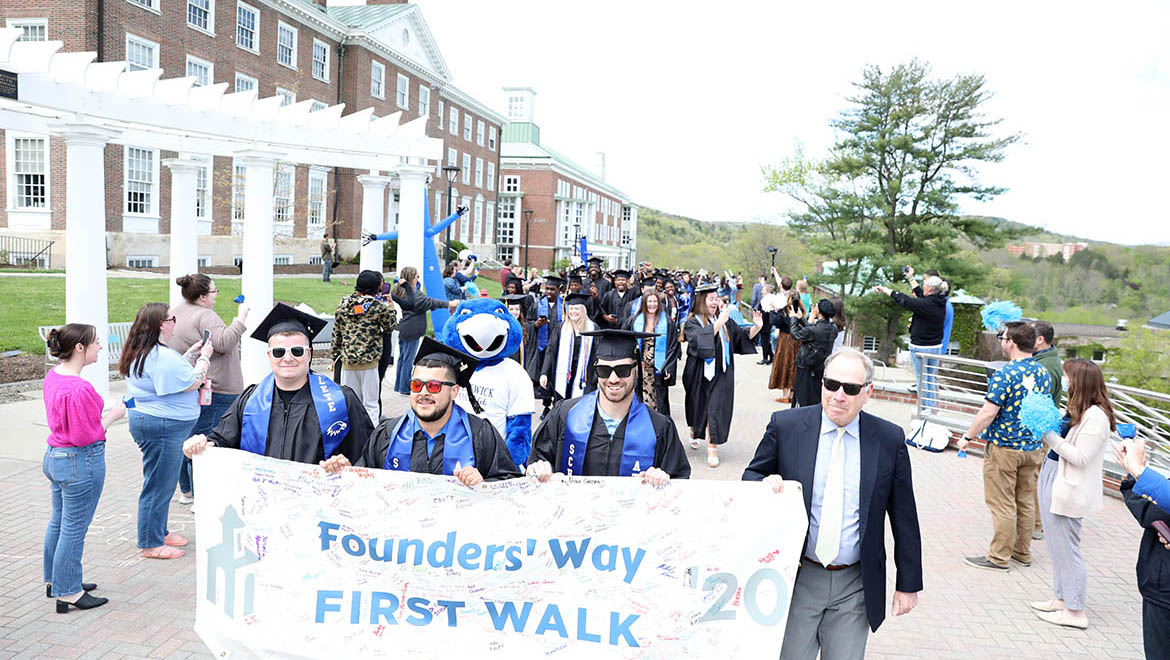 Hartwick College graduates of the Class of 2024 on Last Walk on Founders' Way with Interim President James Mullen