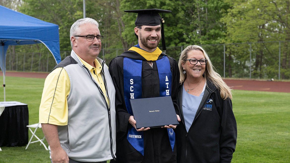 Hartwick College graduate with family