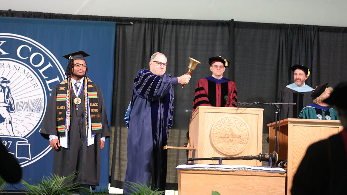 Hartwick College Interim President James H. Mullen, Jr. ringing the Hartwick ceremonial bell to begin Commencement ceremony