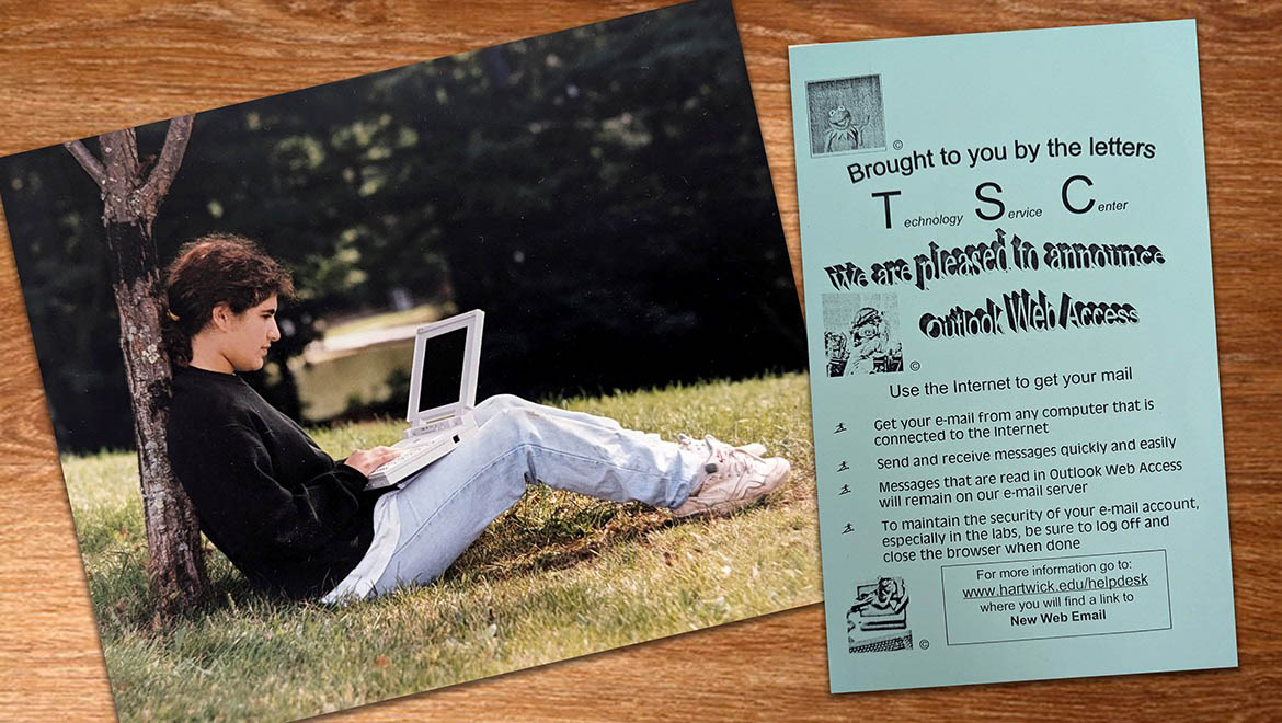 Hartwick College student sitting under tree using computer and TSC flier