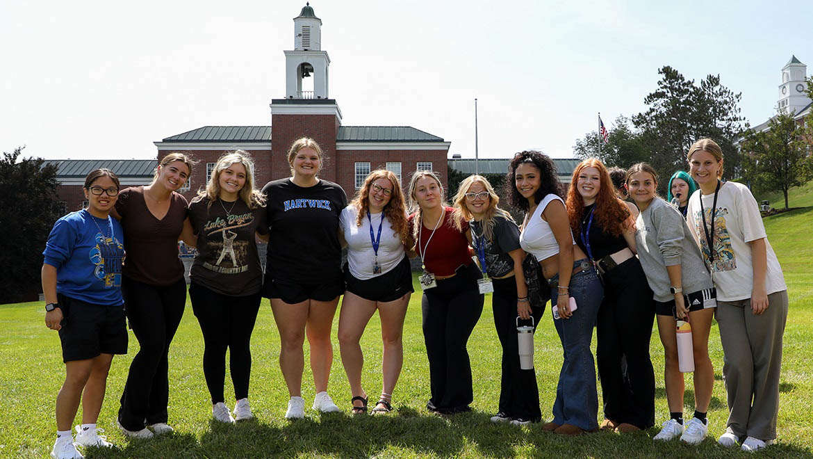 Hartwick College new students on Frisbee Field with Yager Hall in the background