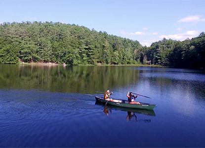 Hartwick College students in canoe on Pine Lake