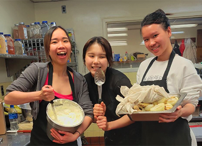 Hartwick College students in kitchen cooking