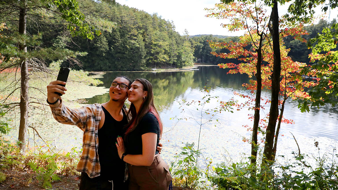 Hartwick College alumni taking selfie at Pine Lake