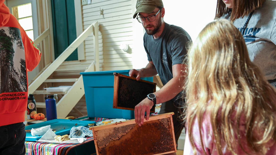 Honey removal from bee hives at Hartwick College's Pine Lake Environmental Campus during True Blue Weekend