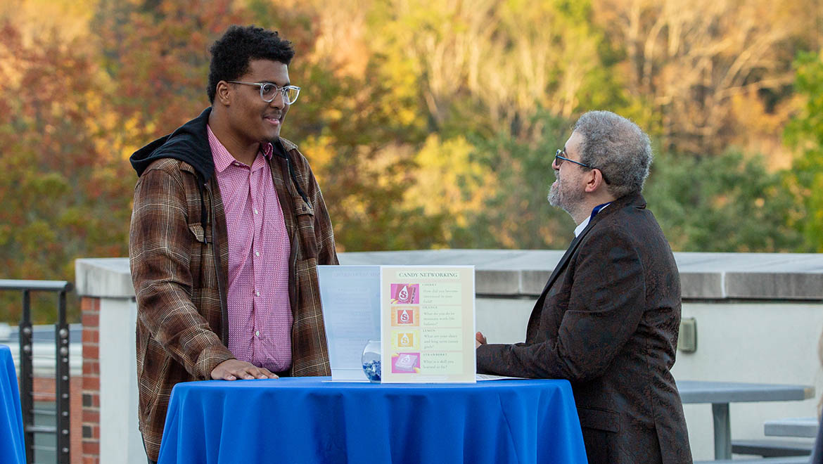 Hartwick College student networking with mentor during True Blue Weekend