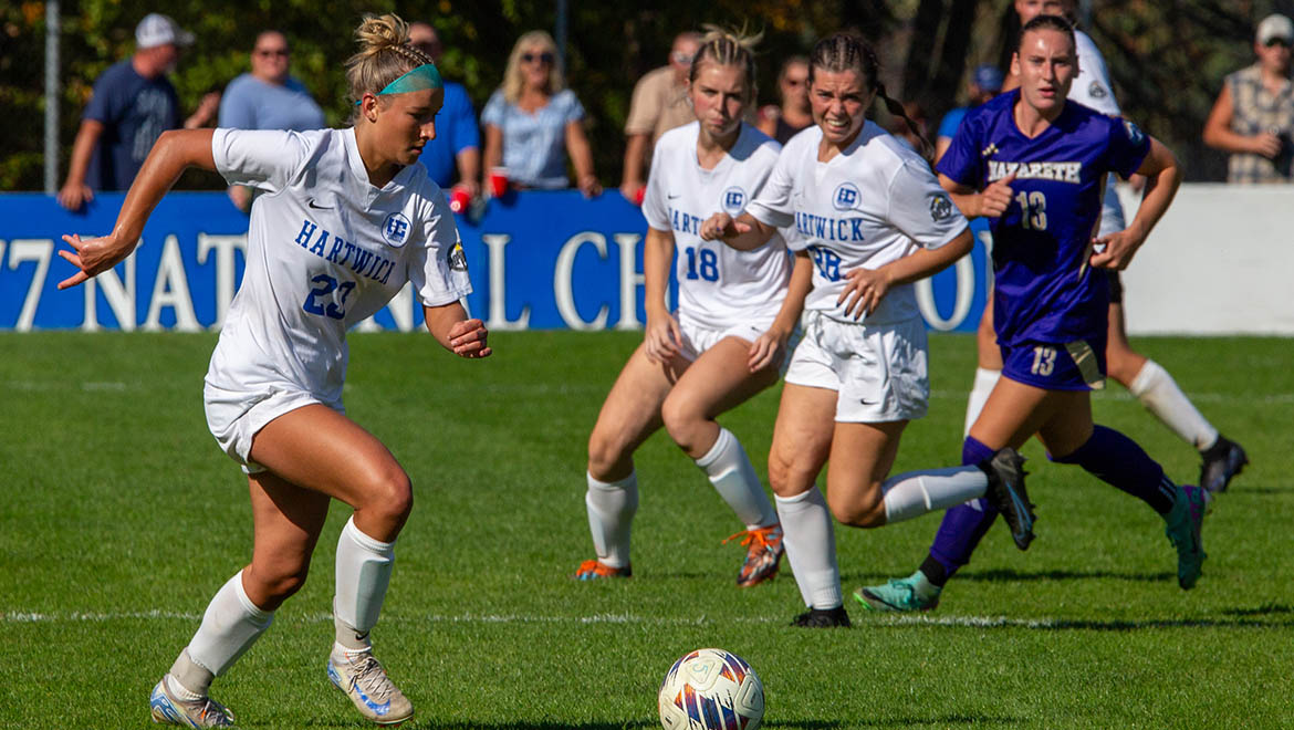 Hartwick College Women's soccer players during game on True Blue Weekend