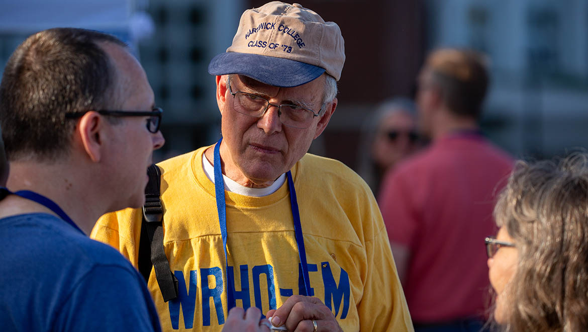 Hartwick College alumnus wearing class of 1973 hat and WRHO radio station shirt