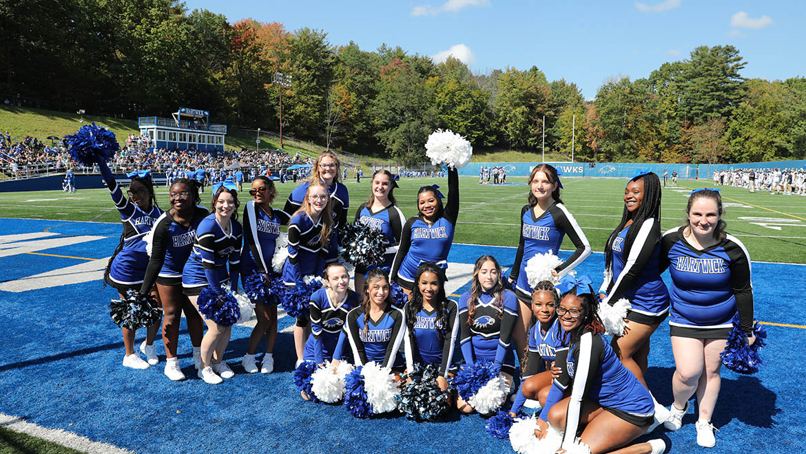 Hartwick College cheerleaders at football game during True Blue Weekend