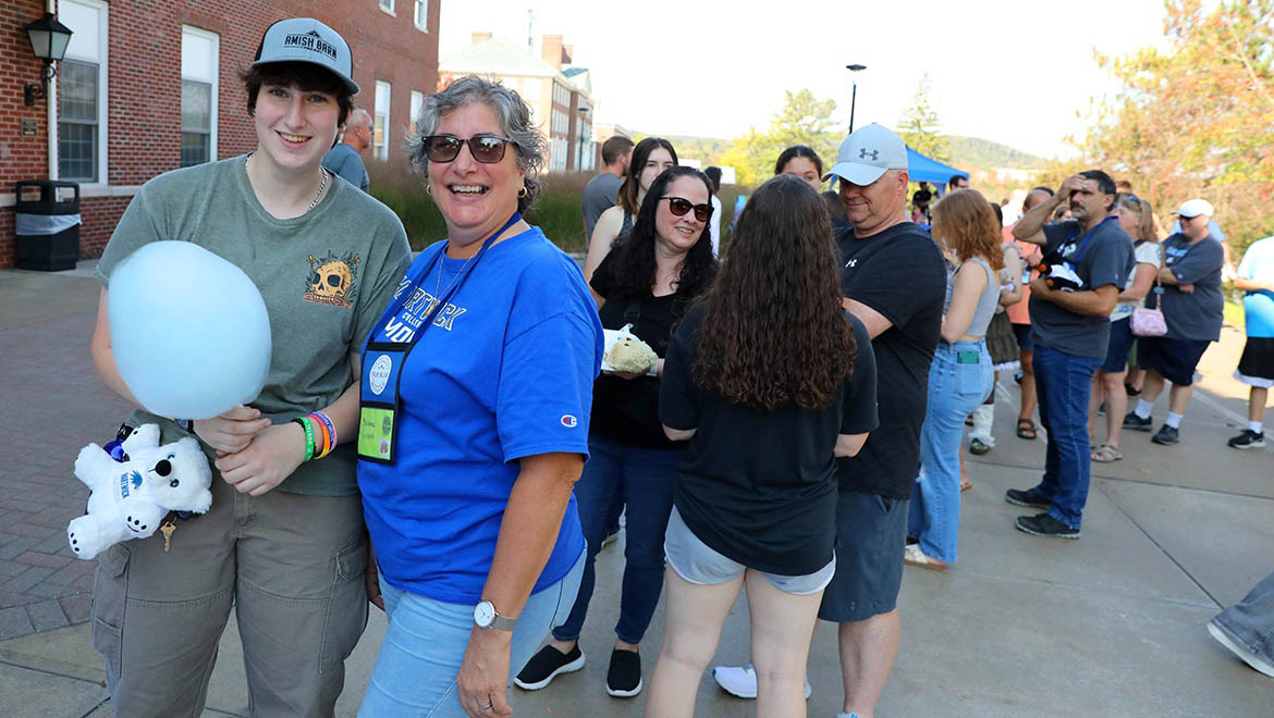 Hartwick College alumni, students and families gather on Founders' Way during True Blue Weekend