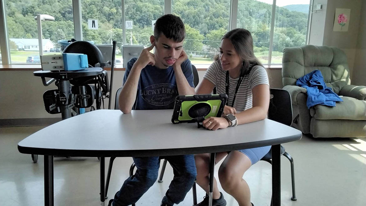 Hartwick College intern working with Springbrook student