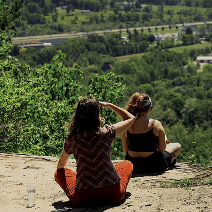 Hartwick College students meditating at Table Rock Trail overlook