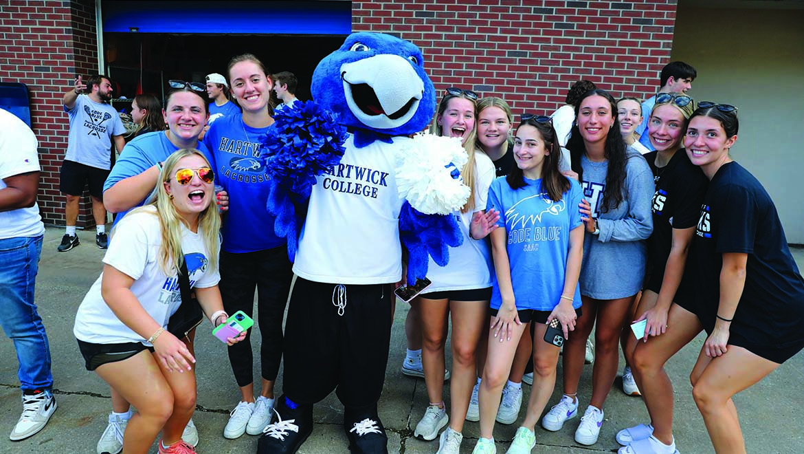 A spirited group of students gathered around Swoop, capturing a moment of Hawk pride and camaraderie.