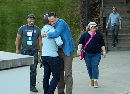 Hartwick alumni greeting eachother on campus during True Blue Weekend