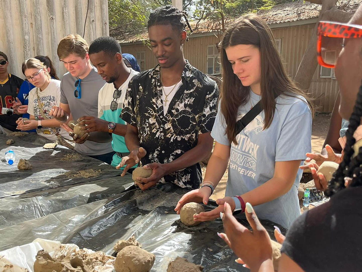 Hartwick students making clay figures in Senegal